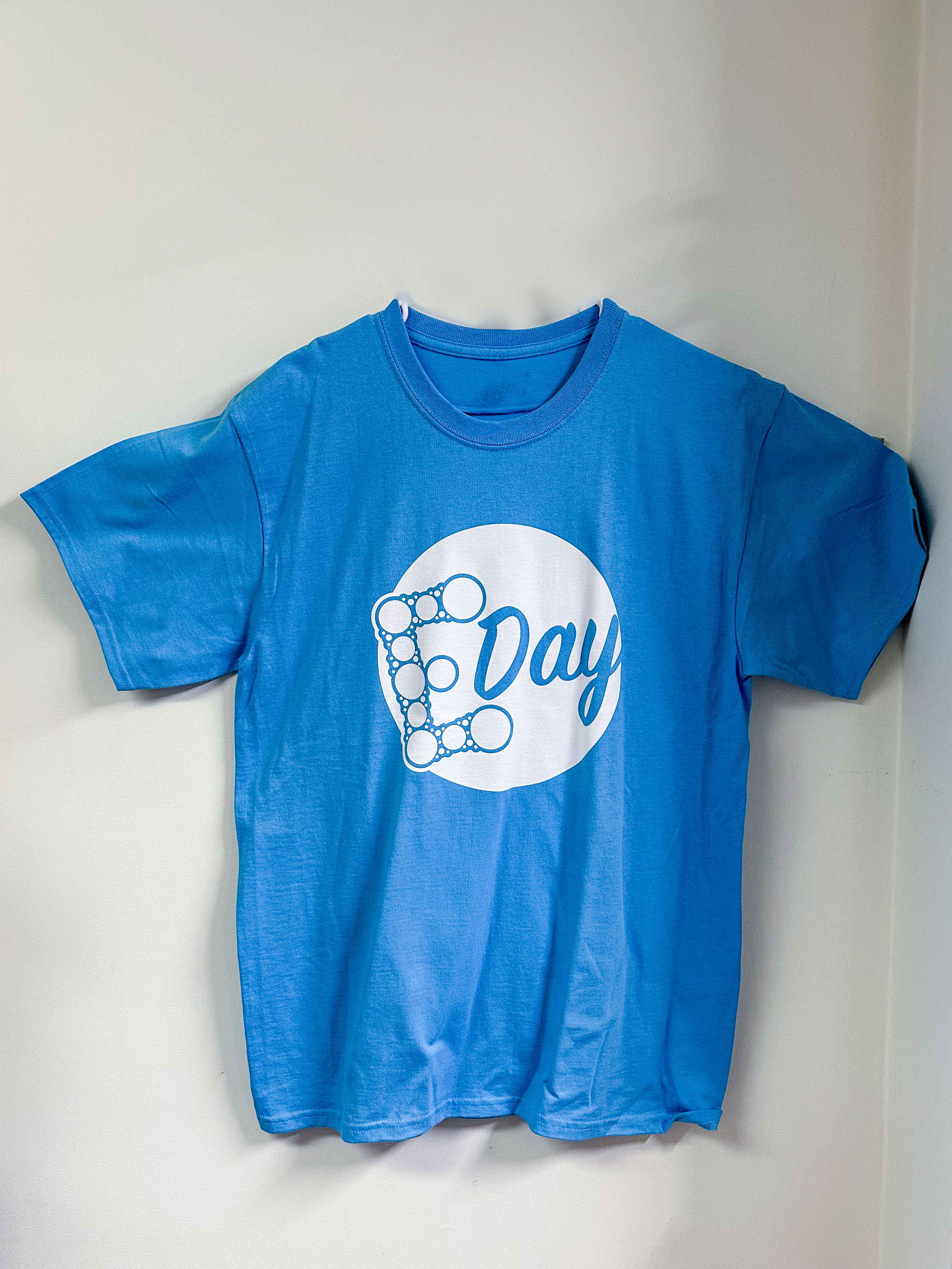Light blue t-shirt with the E-Day logo in a white circle.